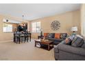 Inviting living room featuring neutral walls, plush seating, and an adjacent dining area perfect for entertaining at 2366 Brockton Way, Henderson, NV 89074
