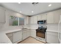 Bright kitchen features modern appliances, white cabinets, and light countertops at 2431 Lilac Cove St, Las Vegas, NV 89135