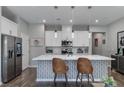 Beautiful kitchen with a large island, modern appliances, pendant lighting, and stylish decor at 2530 Catallo St, Henderson, NV 89044
