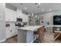 Spacious kitchen island with a sleek white countertop, modern appliances, and decorative pendant lighting at 2530 Catallo St, Henderson, NV 89044