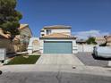 Charming two-story home featuring an attached two-car garage and a well-manicured lawn at 332 Dockside Ct, Las Vegas, NV 89145