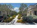 Picturesque view of the community walkway lined with green landscaping and homes at 3493 Arcadian King Ave, Las Vegas, NV 89106