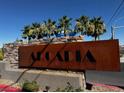 Welcoming Arcadia community sign with stone accents and lush palm trees in the background at 3493 Arcadian King Ave, Las Vegas, NV 89106