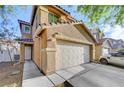 Charming two-story home with a two-car garage, a walkway and a driveway at 4215 Macadamia Dr, Las Vegas, NV 89115