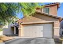 Close up of the garage of a charming two-story home with landscaping at 4215 Macadamia Dr, Las Vegas, NV 89115