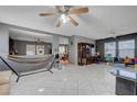 Spacious living room features tile flooring and ceiling fans, perfect for entertaining at 4215 Macadamia Dr, Las Vegas, NV 89115