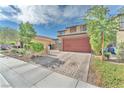 View of the home showcasing the driveway and desert landscaping, as well as the beautiful curb appeal at 4332 Stardusk Falls Ave, North Las Vegas, NV 89084