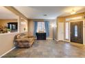 Open-concept living room with neutral paint, tiled floors, and an adjacent dining area at 4512 Long Horse Ct, Las Vegas, NV 89147