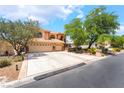 Beautiful two-story home boasting lush landscaping, a spacious driveway, and a convenient three-car garage at 5225 Sandy Cactus Ln, Las Vegas, NV 89149