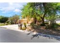 Attractive two-story home showcasing mature landscaping, a three-car garage, and a well-maintained lawn at 5225 Sandy Cactus Ln, Las Vegas, NV 89149
