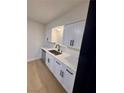 Bright kitchen featuring white cabinets, modern hardware, and stainless steel appliances at 5617 Alfred Dr, Las Vegas, NV 89108