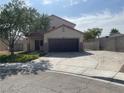 Charming two-story home featuring a well-manicured lawn and an extended driveway at 6043 Cape Clairmont Ct, North Las Vegas, NV 89031