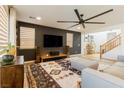 Modern living room with a large flat-screen TV, comfortable seating, and stylish decor at 6927 Desert Finch St, North Las Vegas, NV 89084