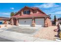 Charming two-story home with a three car garage, low maintenance yard and a spacious driveway at 7720 Leavorite Dr, Las Vegas, NV 89128