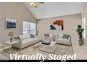Bright living room with large windows and vaulted ceiling at 7720 Leavorite Dr, Las Vegas, NV 89128