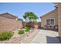 Picturesque backyard featuring a lovely water fountain, patio seating, and desert-friendly landscaping at 7816 Glowing Peak St, Las Vegas, NV 89131