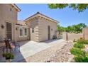 Inviting backyard patio area with seating, mature trees, and low-maintenance desert landscaping at 7816 Glowing Peak St, Las Vegas, NV 89131