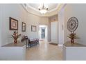 Elegant foyer with tray ceiling, decorative tile flooring, and tasteful decor elements at 7816 Glowing Peak St, Las Vegas, NV 89131