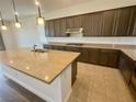 Kitchen featuring granite countertops, tile backsplash, stainless steel range, and wood cabinets at 8550 Lost Pony St, Las Vegas, NV 89148