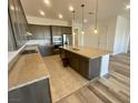 Modern kitchen with an island, stainless steel appliances, granite countertops, and tile backsplash at 8550 Lost Pony St, Las Vegas, NV 89148