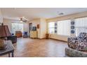 Spacious living room with lots of natural light, neutral paint, and tile flooring at 9022 Sosa Creek Ave, Las Vegas, NV 89149
