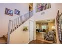 Interior view of the staircase featuring wood and tile and an overlook to the second floor at 9022 Sosa Creek Ave, Las Vegas, NV 89149