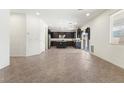 Spacious living room featuring tile floors and recessed lighting, seamlessly connecting to the kitchen at 9268 Wildfire Gorge St, Las Vegas, NV 89139