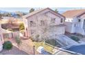 Two-story home with a manicured lawn and an attached garage at 9879 Jazzy June St, Las Vegas, NV 89183