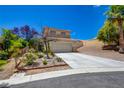 Charming two-story home featuring a well-maintained yard with mature landscaping, a concrete driveway, and an attached two-car garage at 10645 Lace Vine Arbor Ave, Las Vegas, NV 89144