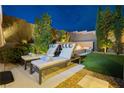 Serene backyard lounge area with comfortable seating and a built-in fire pit at 12382 Tudor Arch Dr, Las Vegas, NV 89138