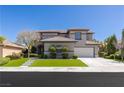 Attractive two-story home with well-maintained lawn, mature trees, and appealing architectural style at 17 Winding Rd, Henderson, NV 89052