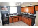 A kitchen featuring wood cabinets, black countertops, and contrasting wall colors at 192 W Alma Ave, Overton, NV 89040