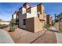 Multi-level condo featuring stucco exterior, tiled roof, and well-maintained landscaping at 2963 Juniper Hills Blvd # 104, Las Vegas, NV 89142