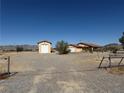 Wide view of property showing house and detached garage/workshop at 3090 N Woodchips Rd, Pahrump, NV 89060