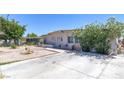Modest single-story home features xeriscaping, mature shade tree, and spacious driveway at 3212 Osage Ave, Las Vegas, NV 89101