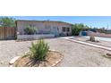 Single-story home with xeriscaping, quaint exterior details, and tidy, low maintenance front yard at 3212 Osage Ave, Las Vegas, NV 89101