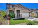 Beautiful two-story home featuring a well-maintained lawn and desert landscaping at 3310 Hillside Garden Dr, Las Vegas, NV 89135
