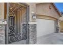 Close-up of the front entrance, showcasing a decorative security gate and stone accents at 3310 Hillside Garden Dr, Las Vegas, NV 89135