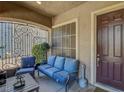 Inviting front porch with comfortable seating and a view of the landscaped yard at 3310 Hillside Garden Dr, Las Vegas, NV 89135