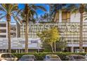The Palms Place featuring well-maintained landscaping, palm trees, and building signage at 4381 W Flamingo Rd # 1905, Las Vegas, NV 89103