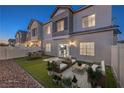 Relaxing backyard with artificial grass, outdoor seating, dining area and privacy fence at 545 Thea St # 1315, Henderson, NV 89052