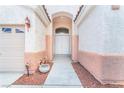 Inviting entryway with double doors, featuring neutral stucco and a decorative planter at 5505 Verbena Creek Ct, Las Vegas, NV 89131