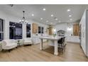 Well-lit kitchen features an island, modern cabinetry, stainless steel appliances, and a cozy seating area at 5573 San Florentine Ave, Las Vegas, NV 89141