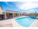 The backyard shows a pool next to a covered patio with an outdoor kitchen at 5600 Old Stable Ave, Las Vegas, NV 89131