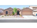 Charming home with a two-car garage and a well-maintained xeriscaped front yard at 5600 Old Stable Ave, Las Vegas, NV 89131