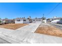 Single-story home boasts a concrete driveway and a bright, white exterior paint at 6204 Parsifal Pl, Las Vegas, NV 89107