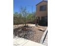 Charming home with low maintenance landscaping, featuring decorative rocks and desert plants at 9175 Titan Hill Ct, Las Vegas, NV 89148