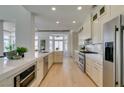 Well-lit kitchen featuring modern stainless steel appliances, ample white cabinets, and quartz countertops at 9425 Villa Ridge Dr, Las Vegas, NV 89134