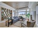 Cozy living room with large windows, stylish furniture, and a decorative bookshelf at 9425 Villa Ridge Dr, Las Vegas, NV 89134