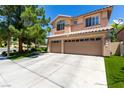 Lovely two-story home with a three-car garage, desert landscaping, and a well-maintained driveway at 9440 Grenville Ave, Las Vegas, NV 89134
